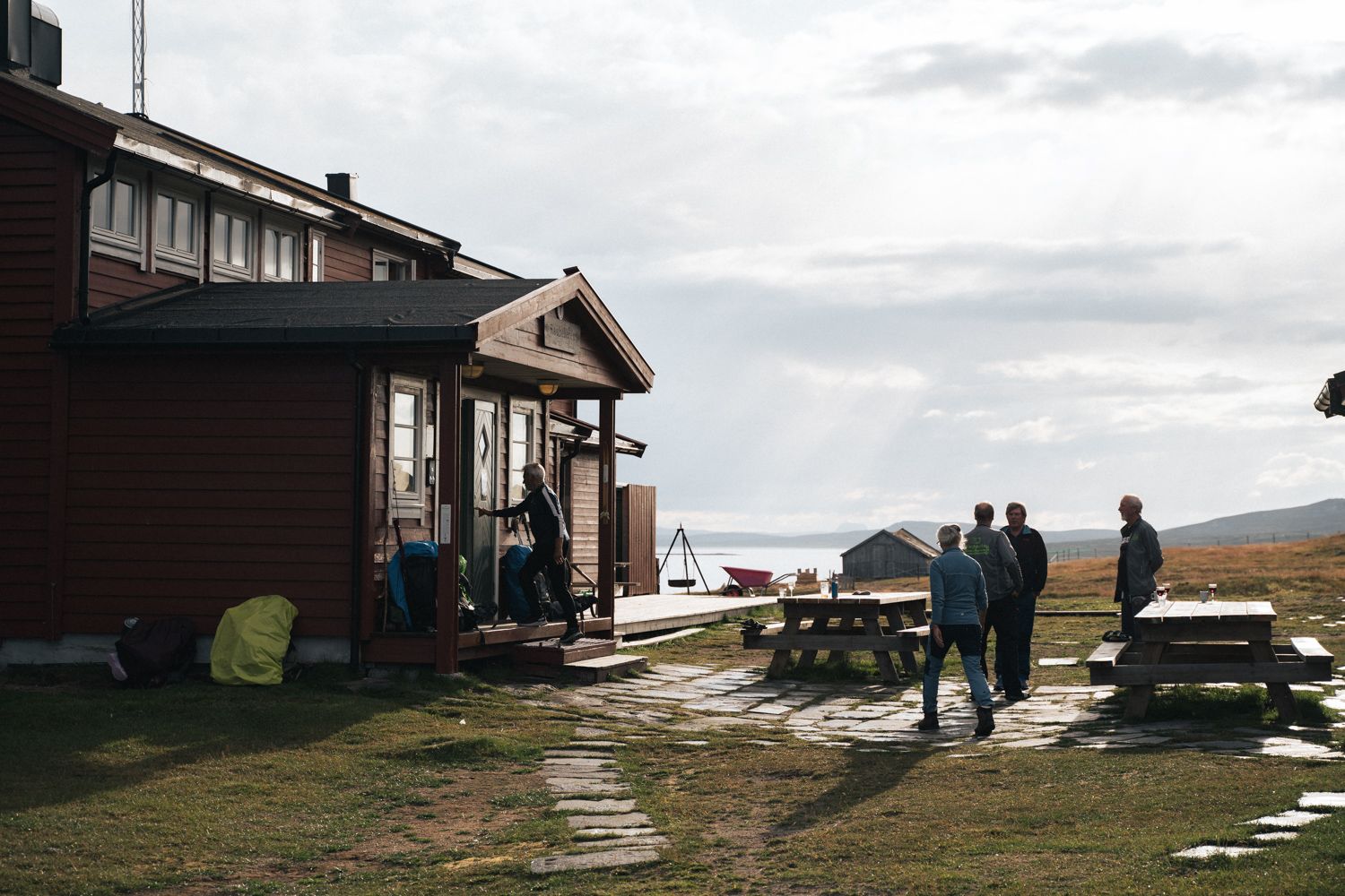 Some people are standing by the entrance to the mountain lodge.
