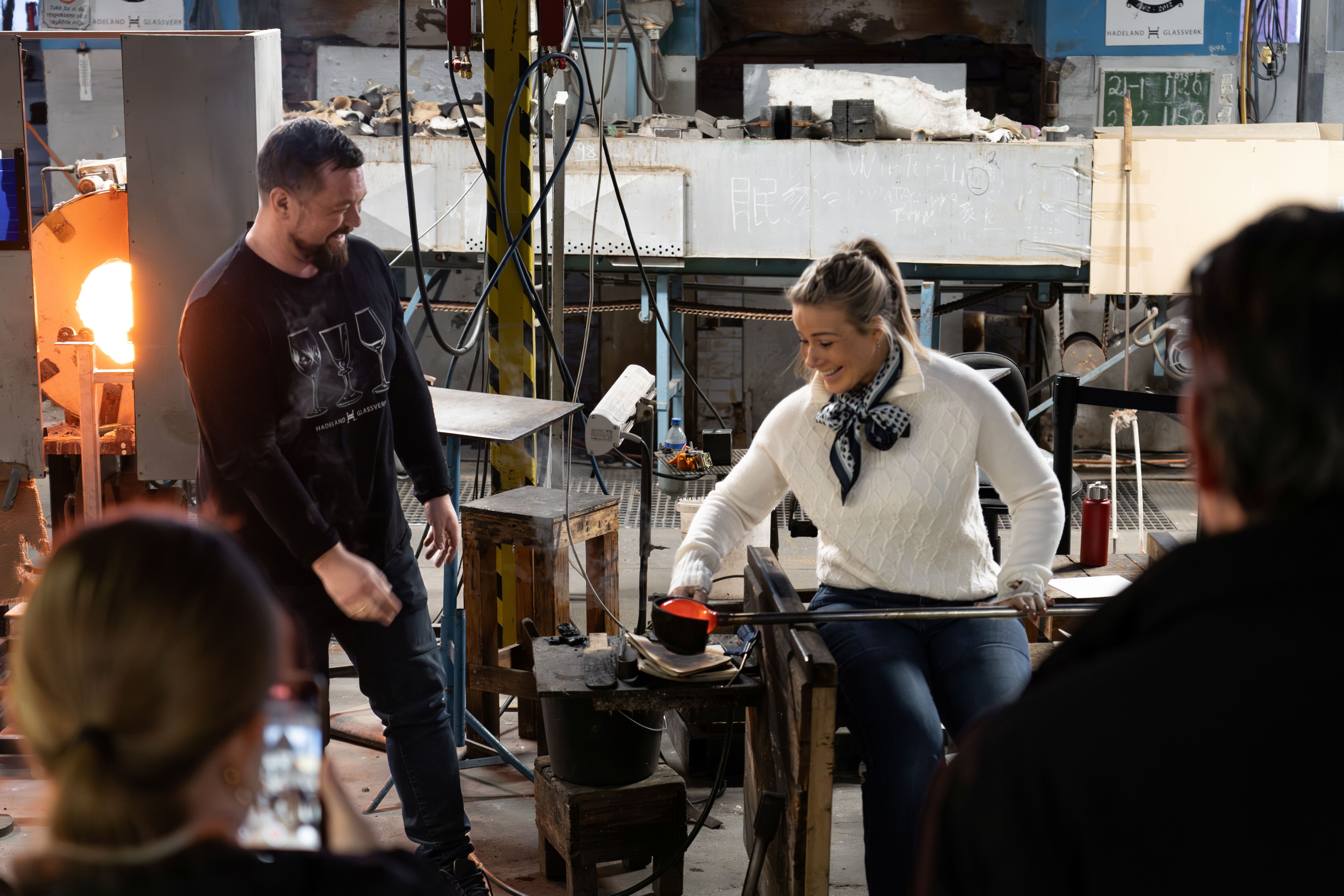 Konferansegruppe på Hadeland Glassverk. Gjest får prøve glassblåsing