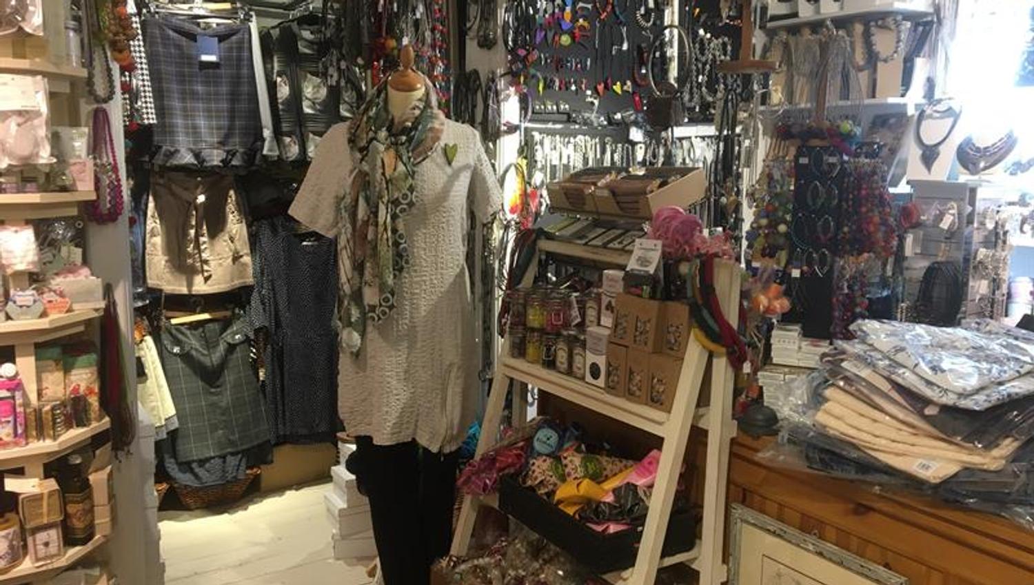 The shop is filled up to the roof with items to buy.