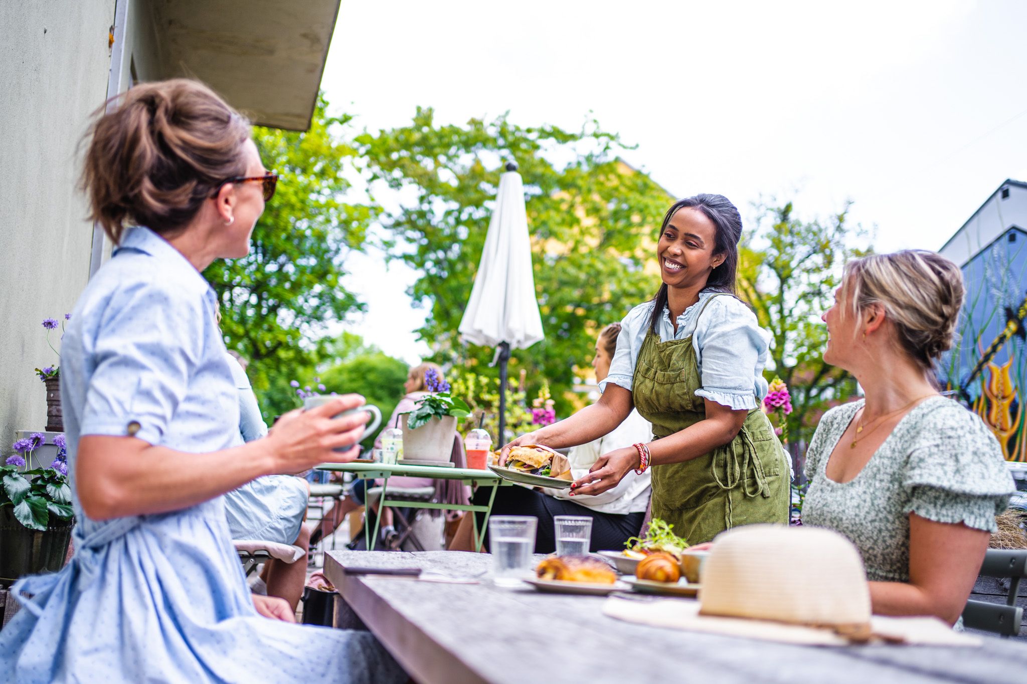 guests at a cafe getting their order
