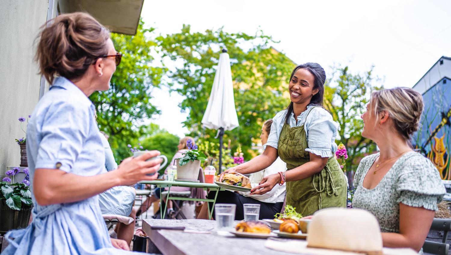 guests at a cafe getting their order