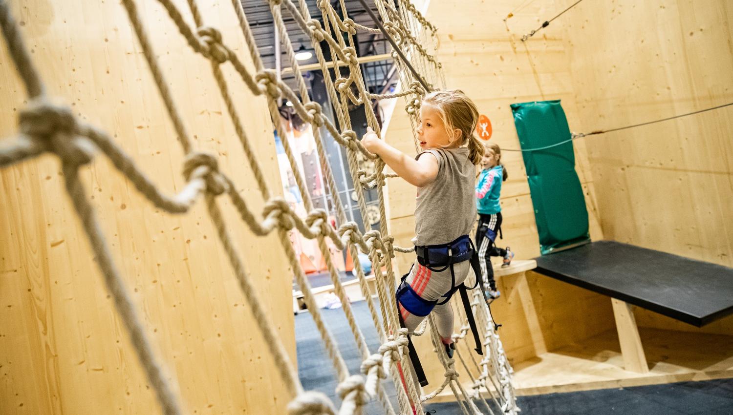 Children on a rope climbing course