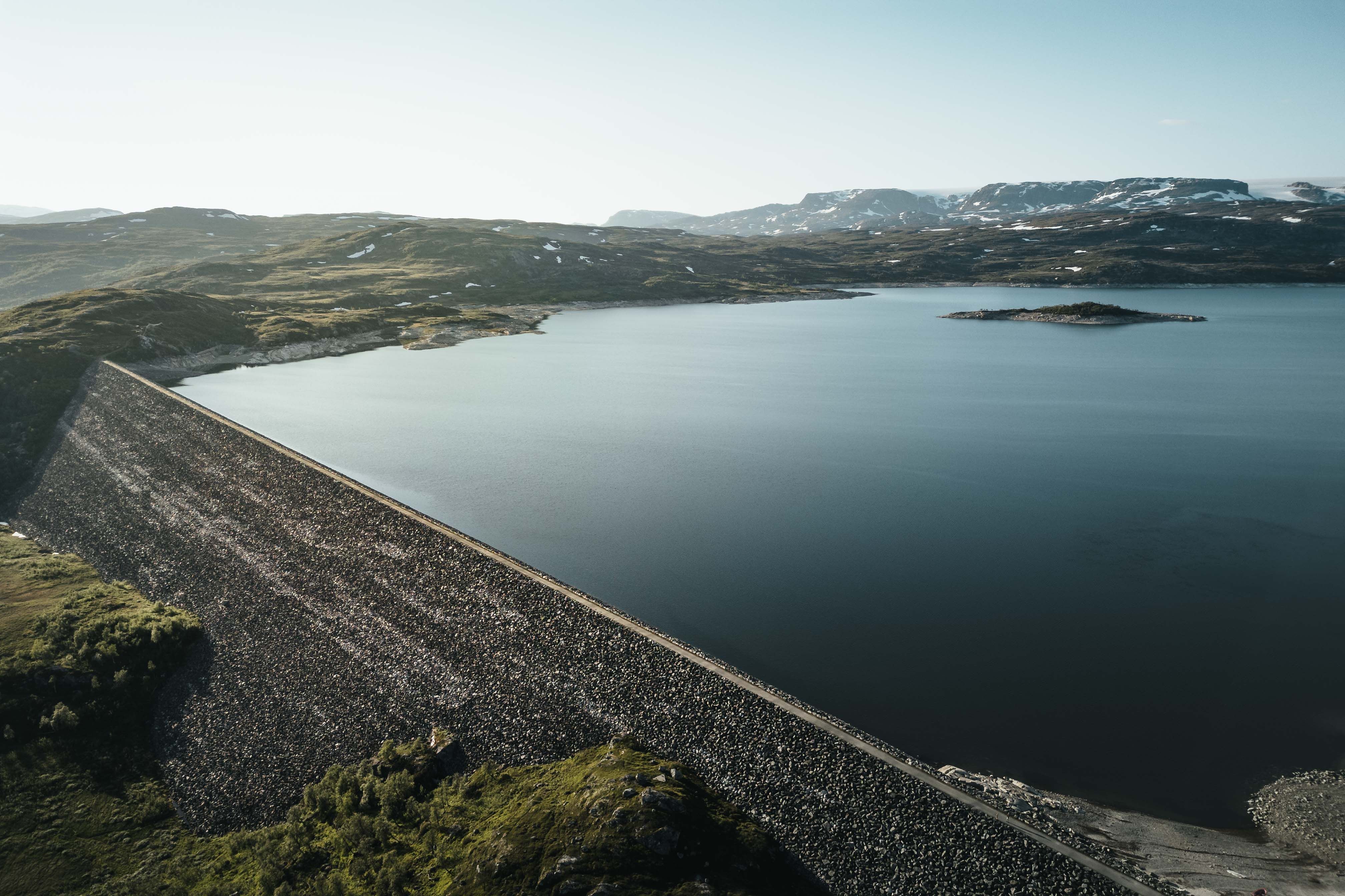 A drone photo of the Sysendammen dam during sunset.