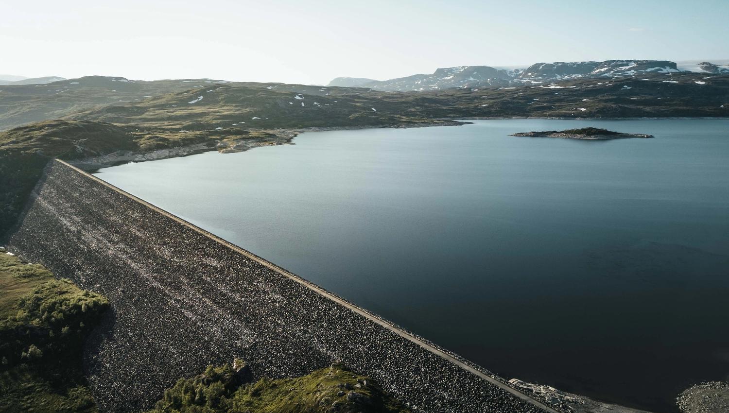A drone photo of the Sysendammen dam during sunset.
