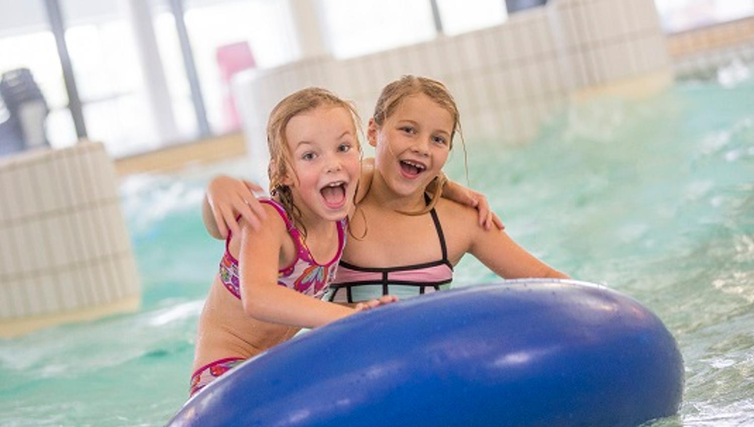 children floating on inflatable ring