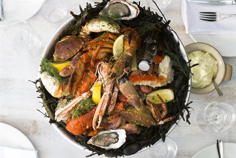 Detail photo of seafood on table set for dining.
