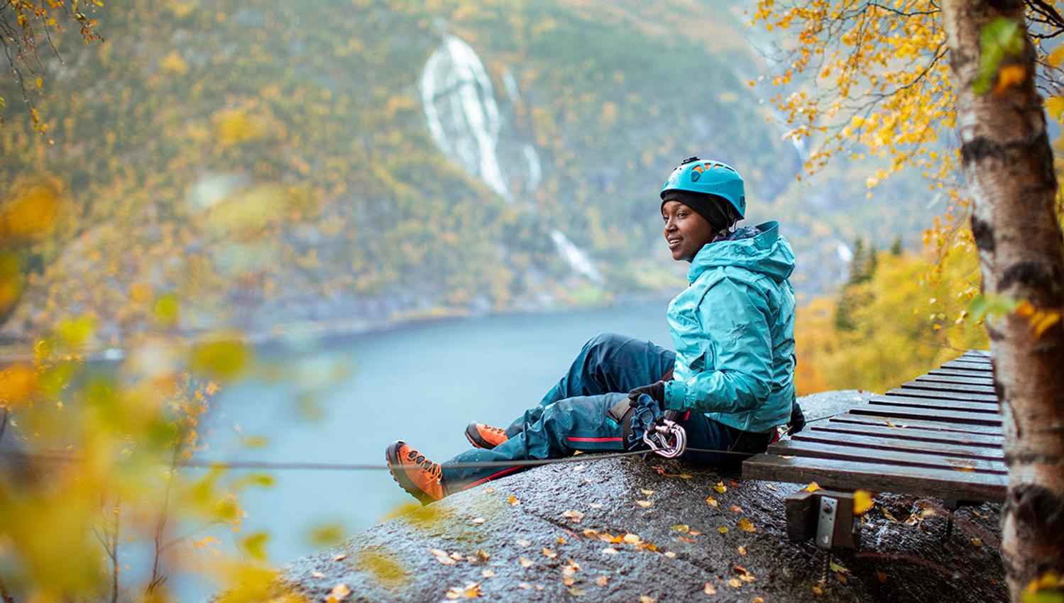 Rest stop on Via Ferrata Tyssedal in autumn colors with fjord views.