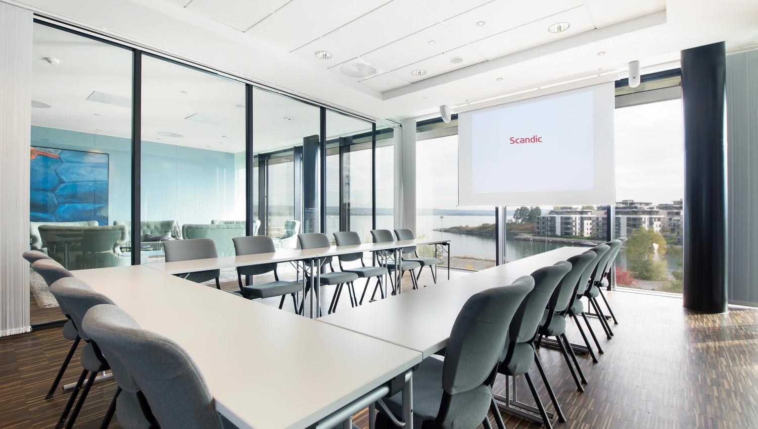 conference hall with horseshoe-setup and conference technology