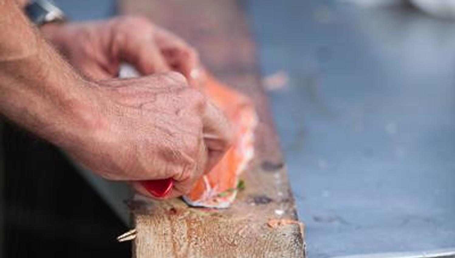 Someone filleting a piece of fish