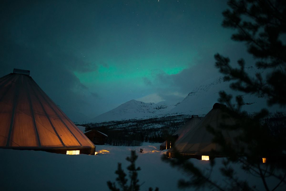 The aurora shows itself behind the fog