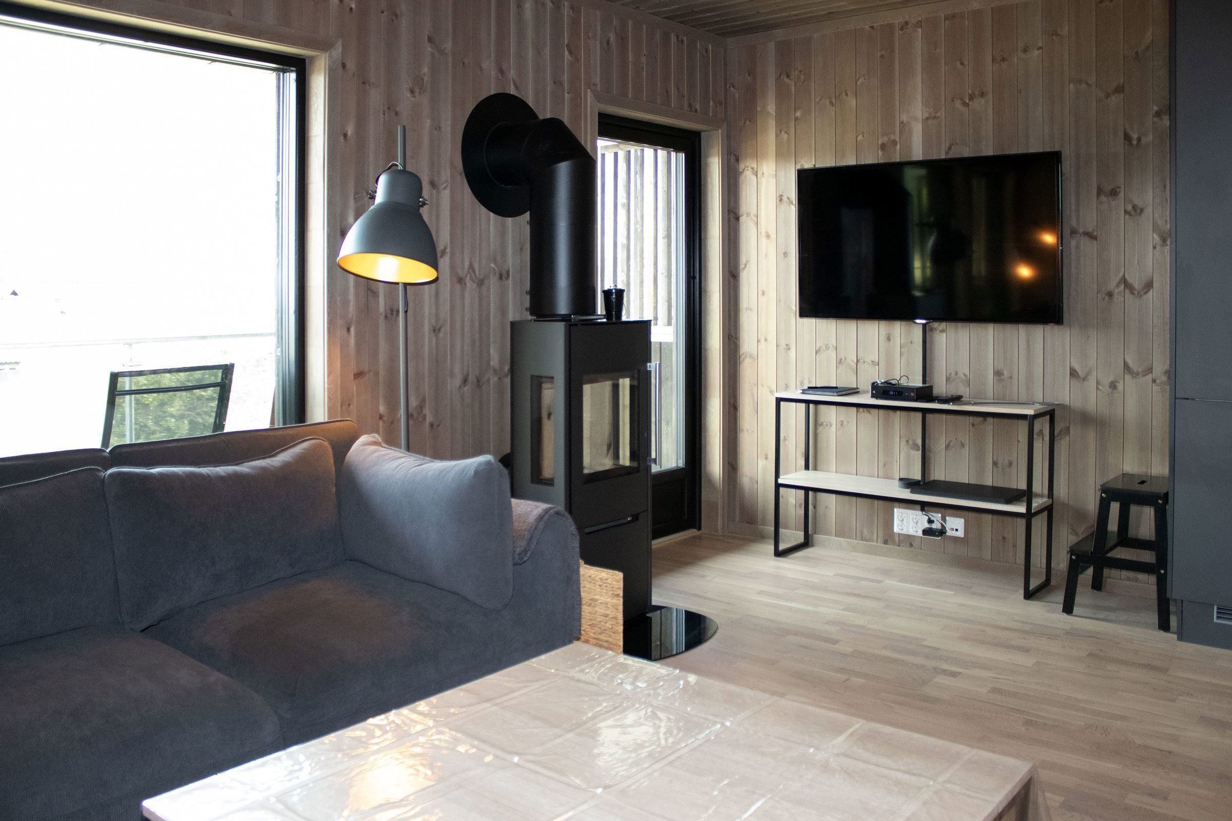 Ein Wohnzimmer mit Fernseher und Sofa.