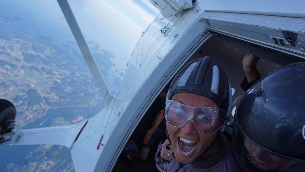 One who looks excited on her way out of the plane in the air