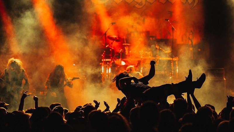 Person crowdsurfing while Gorgoroth is playing on stage