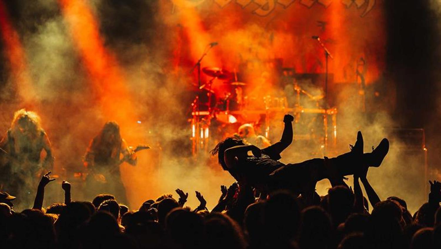 Person crowdsurfing while Gorgoroth is playing on stage