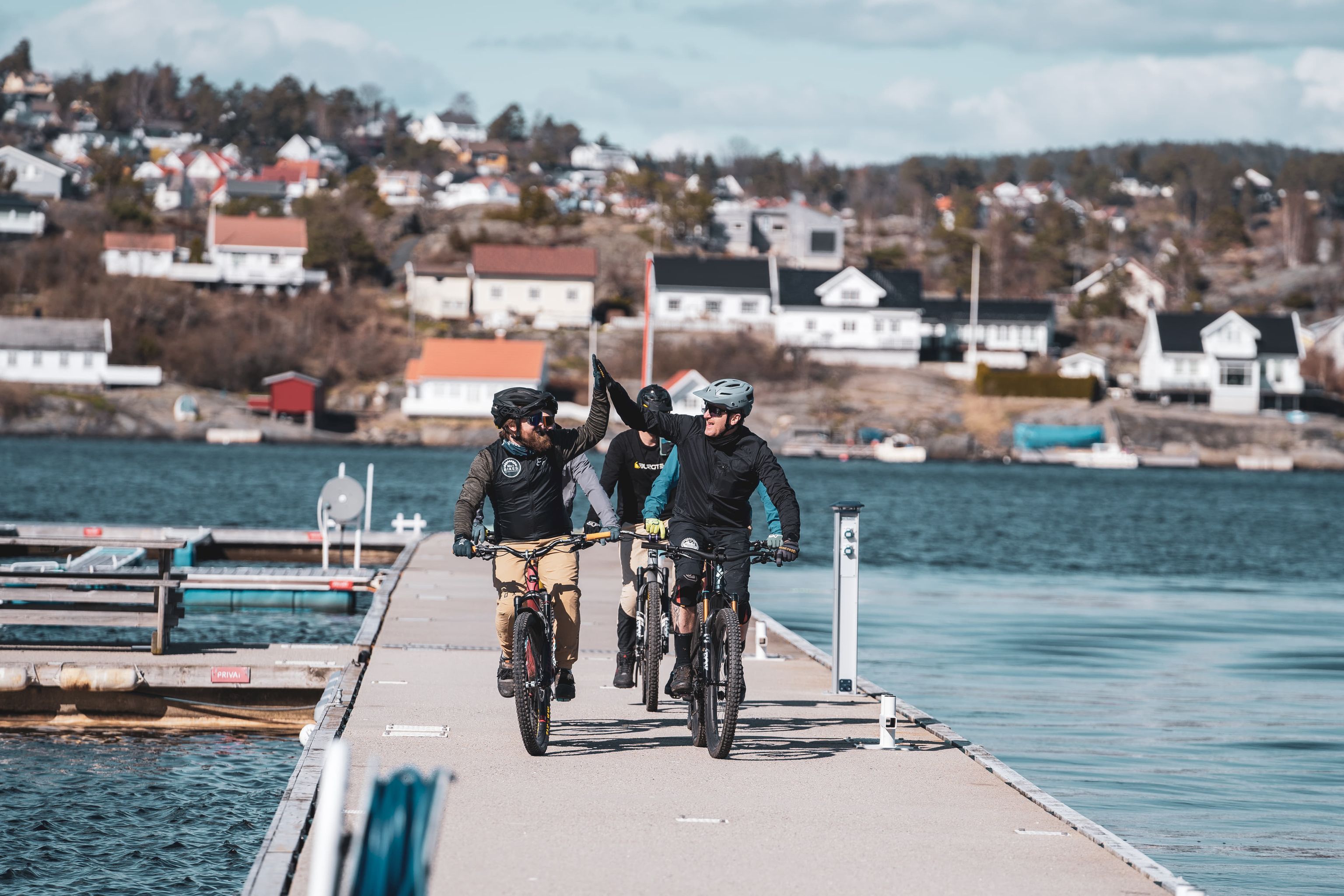 Cyclists riding along a pier