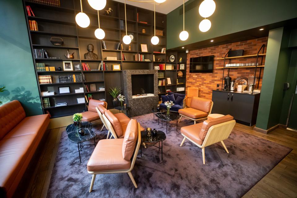 Lounge with sofa and chairs. Bookshelf. Hotell Bondeheimen, Oslo. Photo