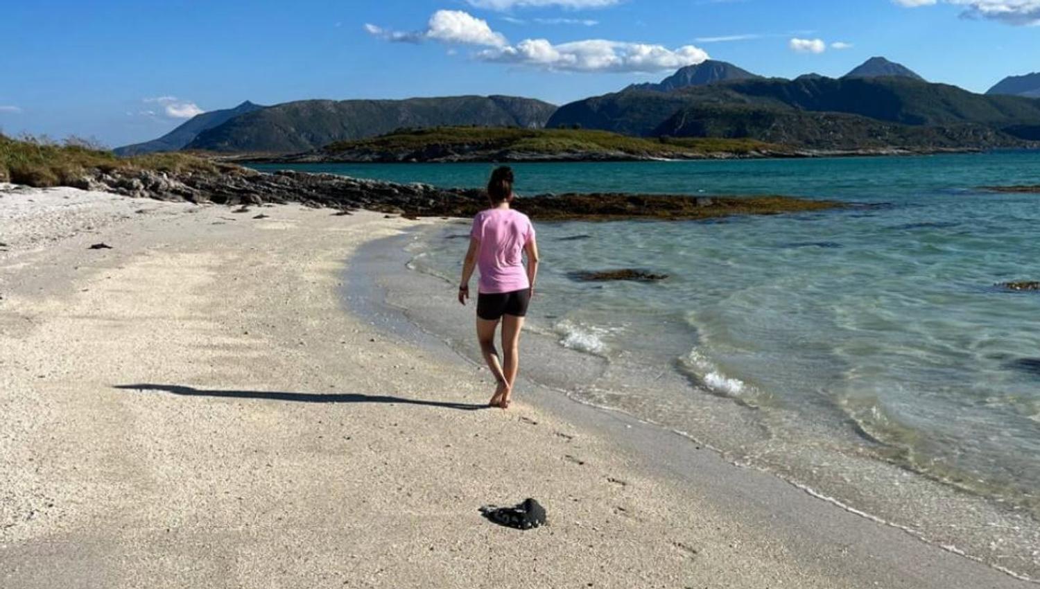 Guest walking on the beach