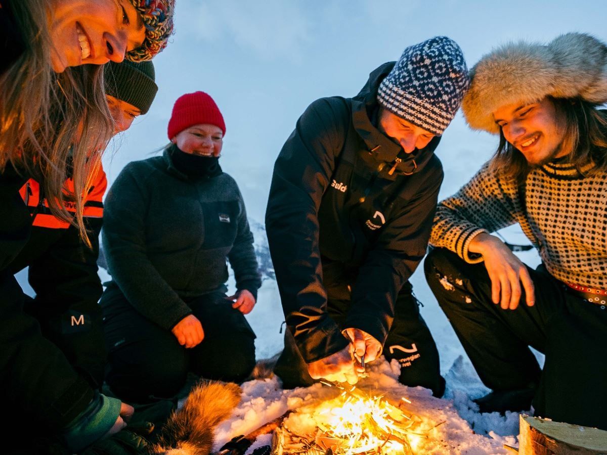 A group of guests gathered around a fire