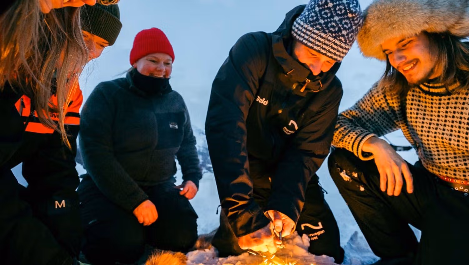A group of guests gathered around a fire