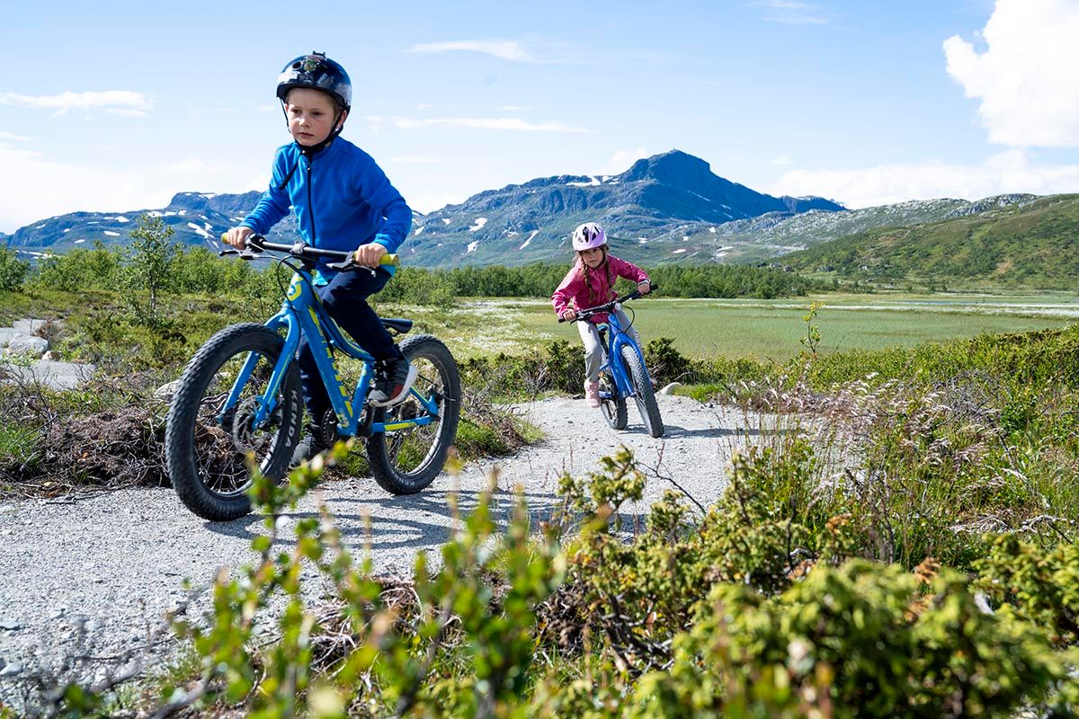 Children cycling the trails of Beitostølen Trail Arrena. Beautiful surroundings with Bitihorn in the background.