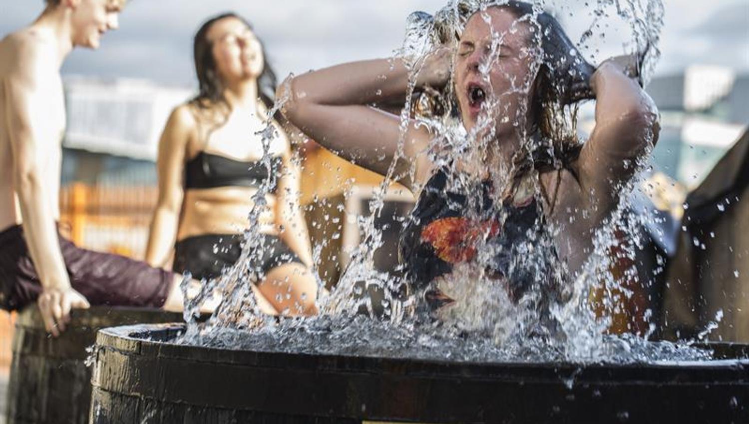 A woman cooling down in a tub of cold water