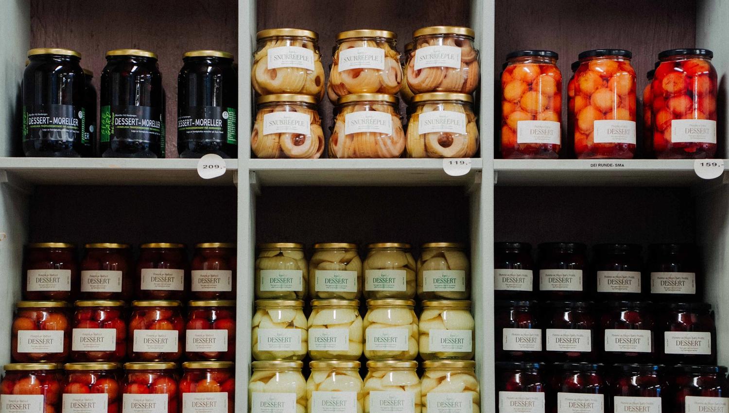 Shelf with preserved fruits from Syse Gard, ready for sale in the farm shop.