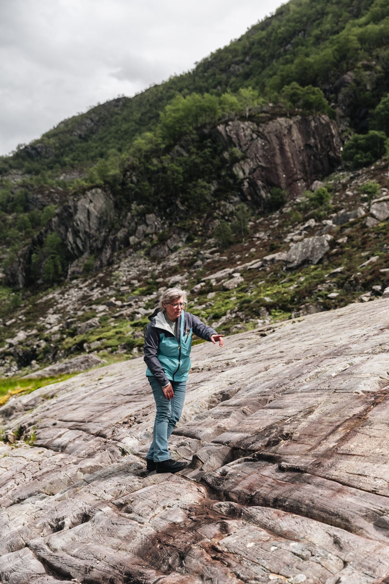 A guide with visitors exploring the Vingen rock art landscape on a guided tour.