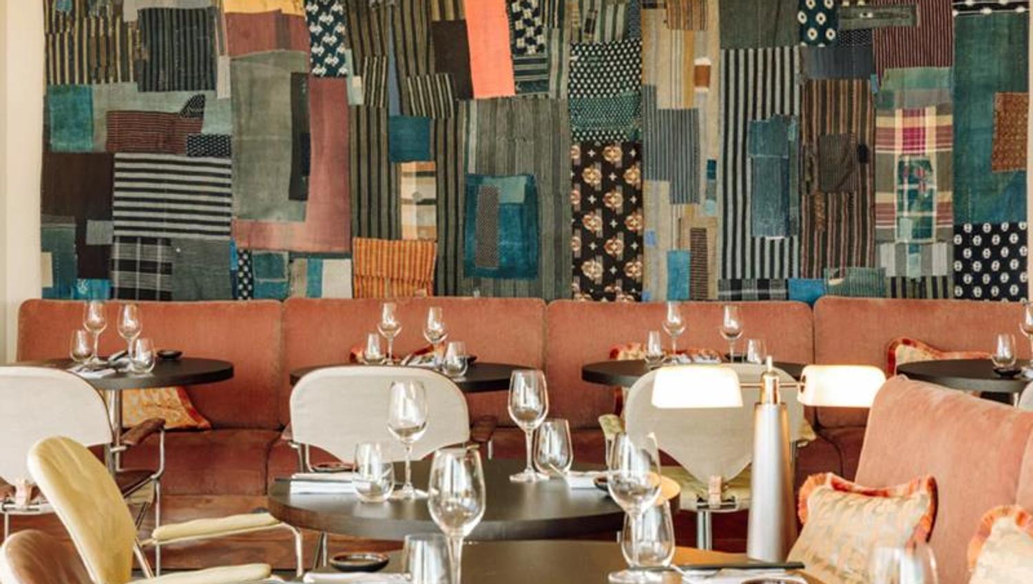 Red seating section with tables set for dining, wall decorations in the background.