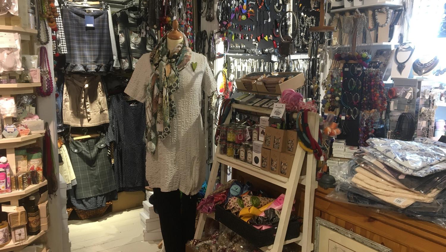 The shop is filled up to the roof with items to buy.