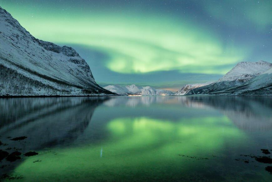 Northern lights over a fjord