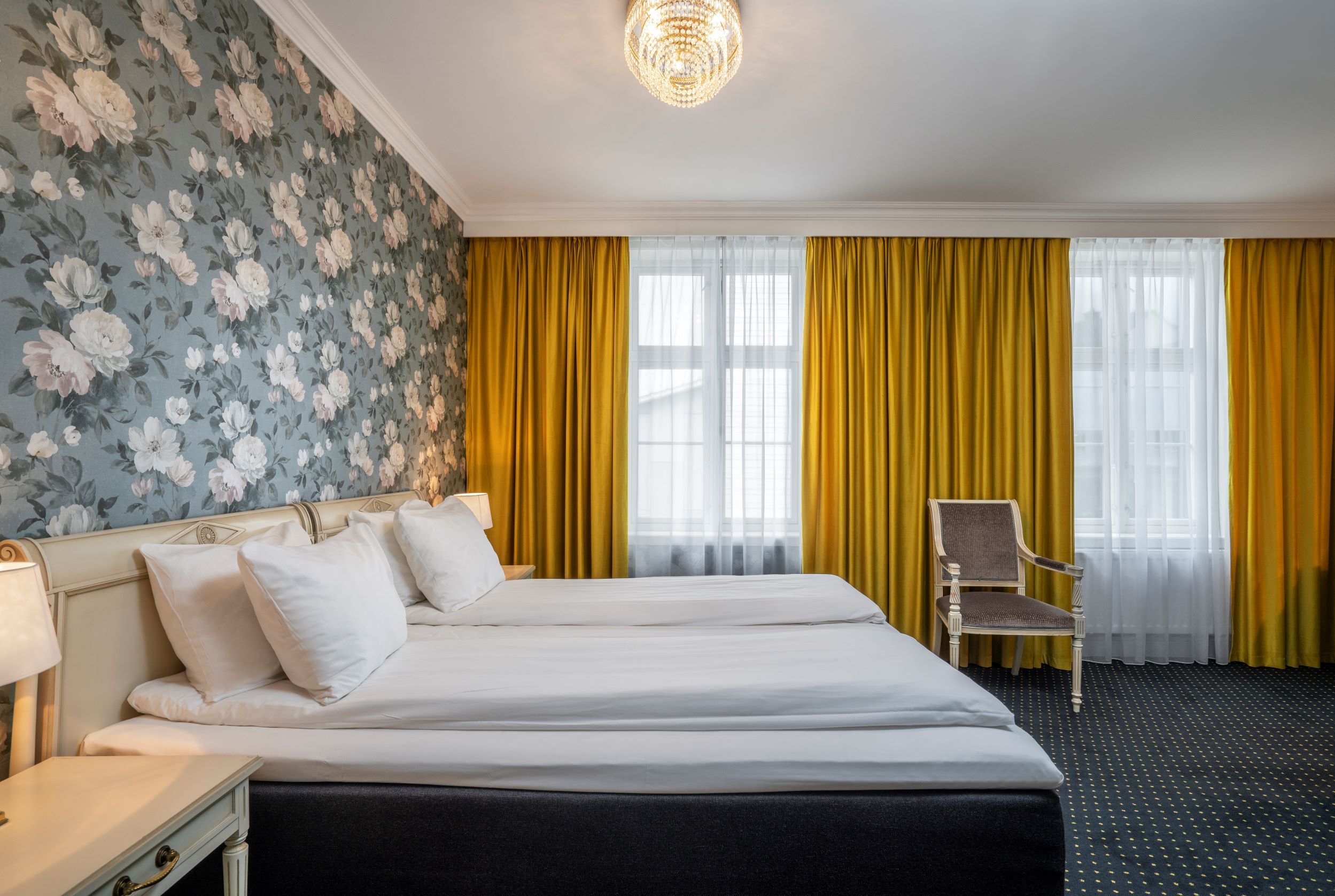 Bright and spacious hotel room at Thon Hotel Sandven, featuring exclusive decor and charming details.