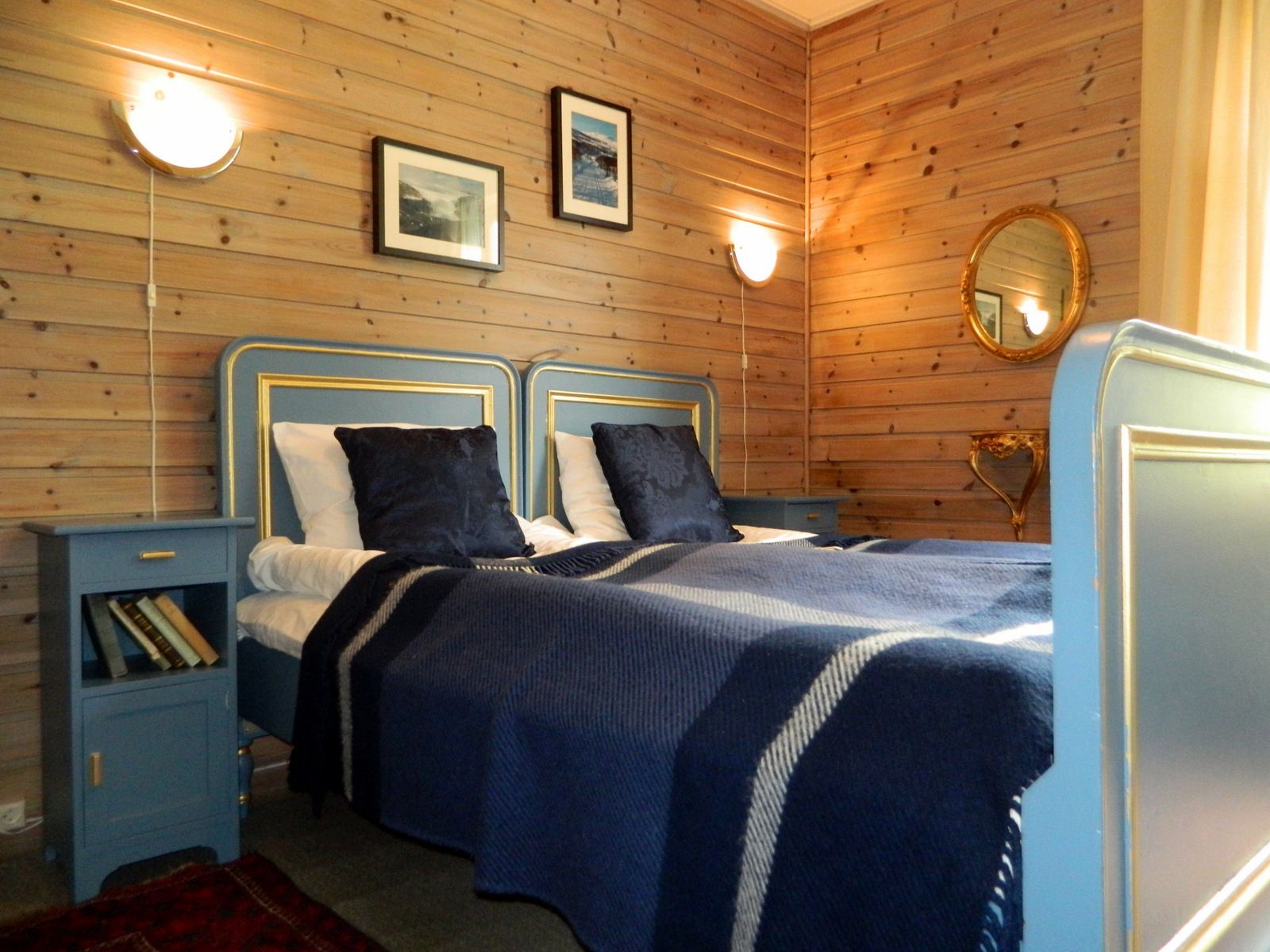 A room with a double bed, blue details.