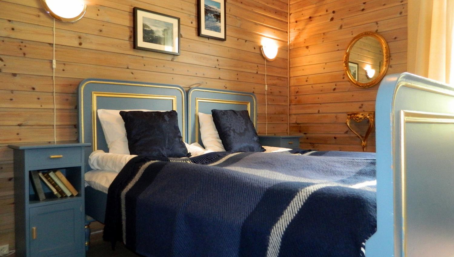 A room with a double bed, blue details.