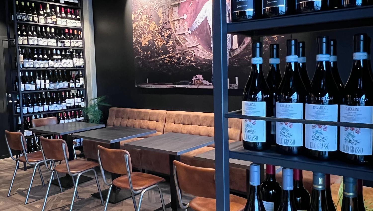 Wine bottles around in the bar on shelves and seatings