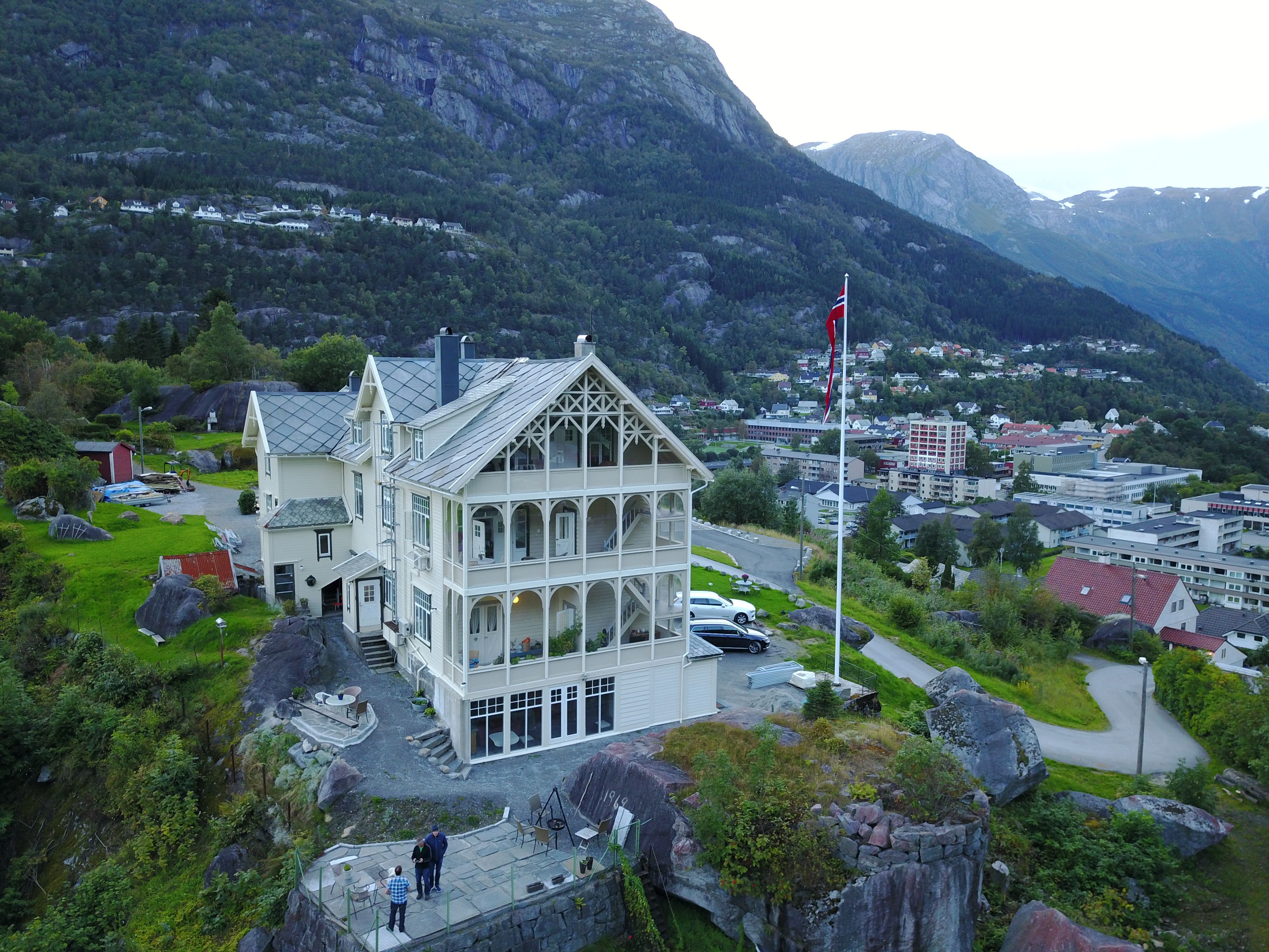Vikinghaug Apartments overlooking Odda town, offering panoramic views of the fjord and steep mountain slopes in Hardanger.