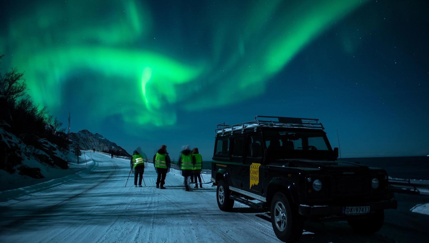 A truck and guests under the Northern Lights