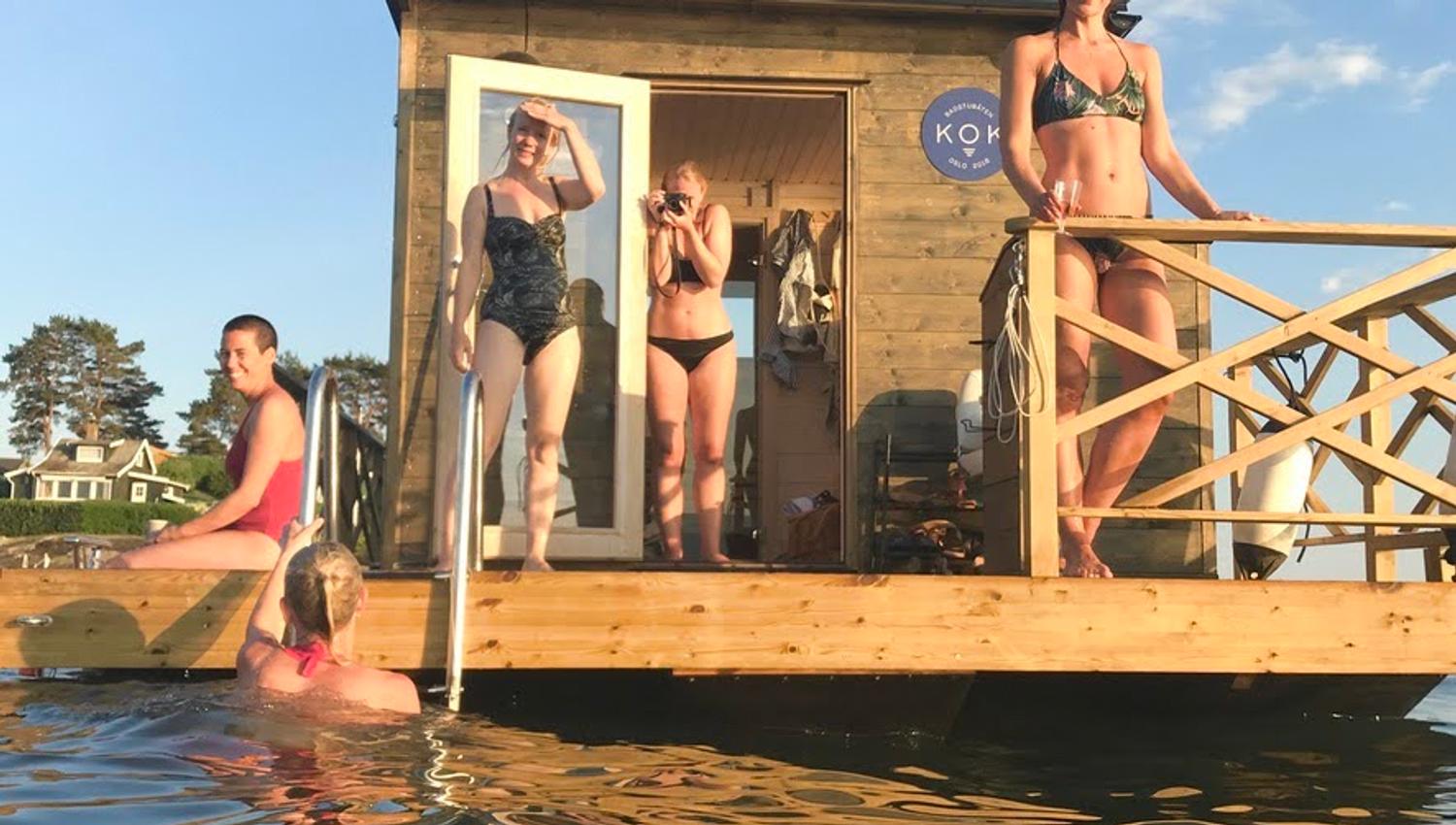 Floating sauna on the water with people.