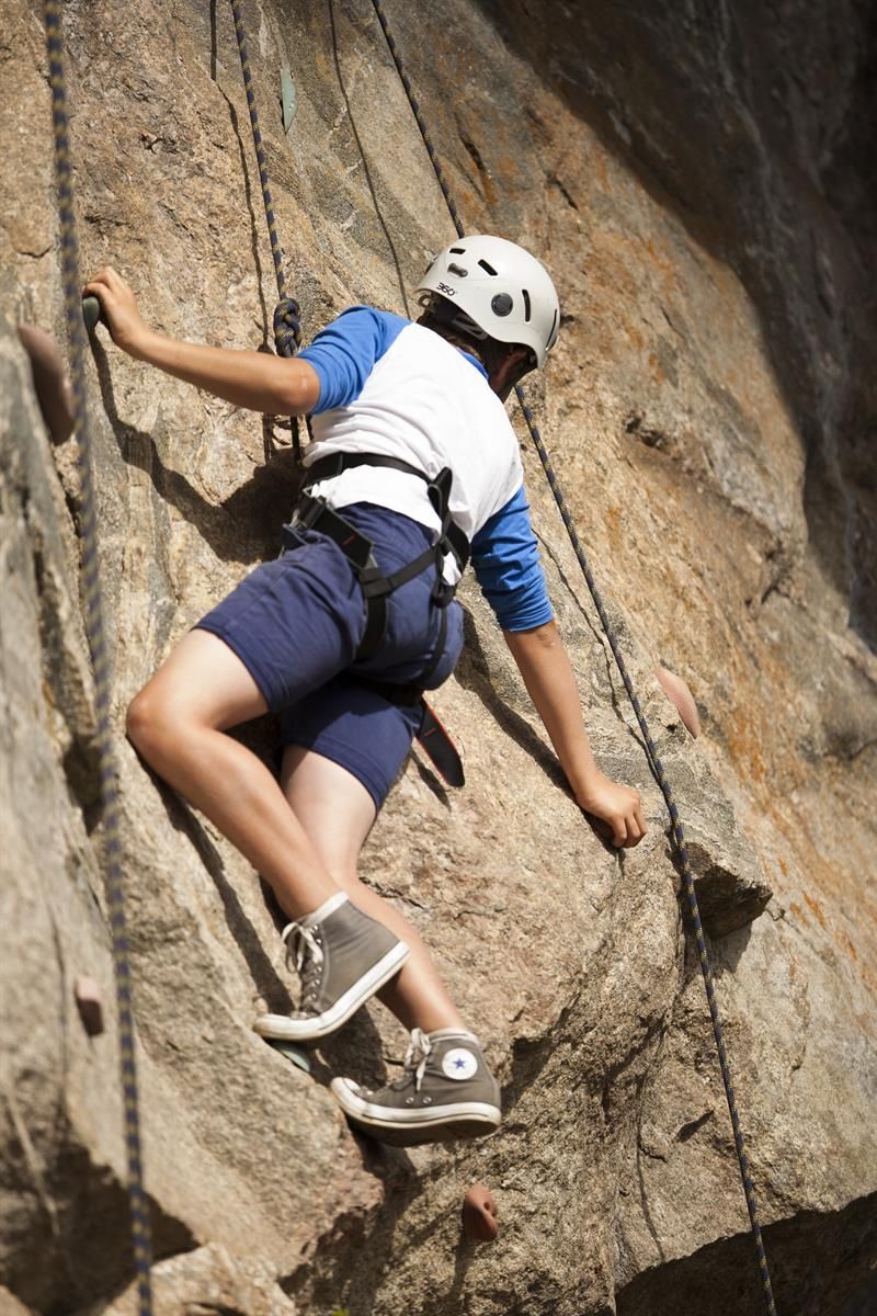Young boy is rappelling