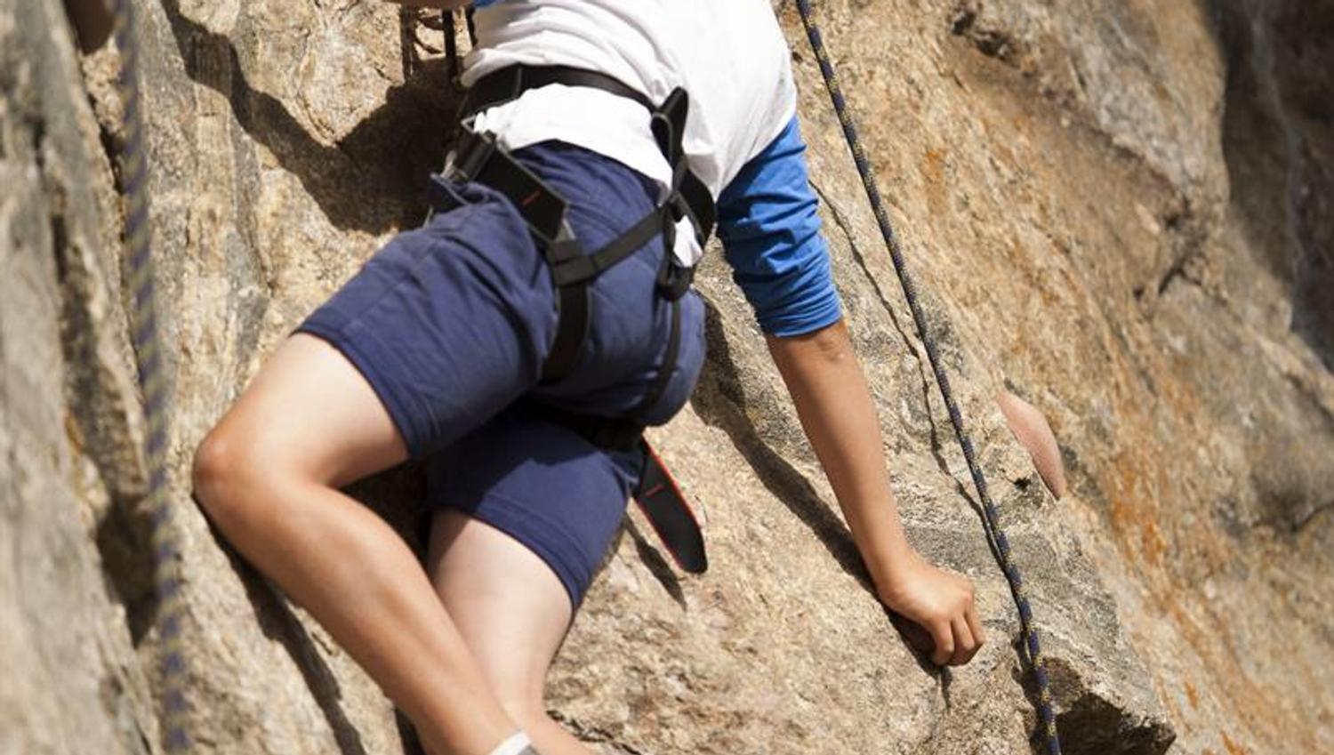 Young boy is rappelling