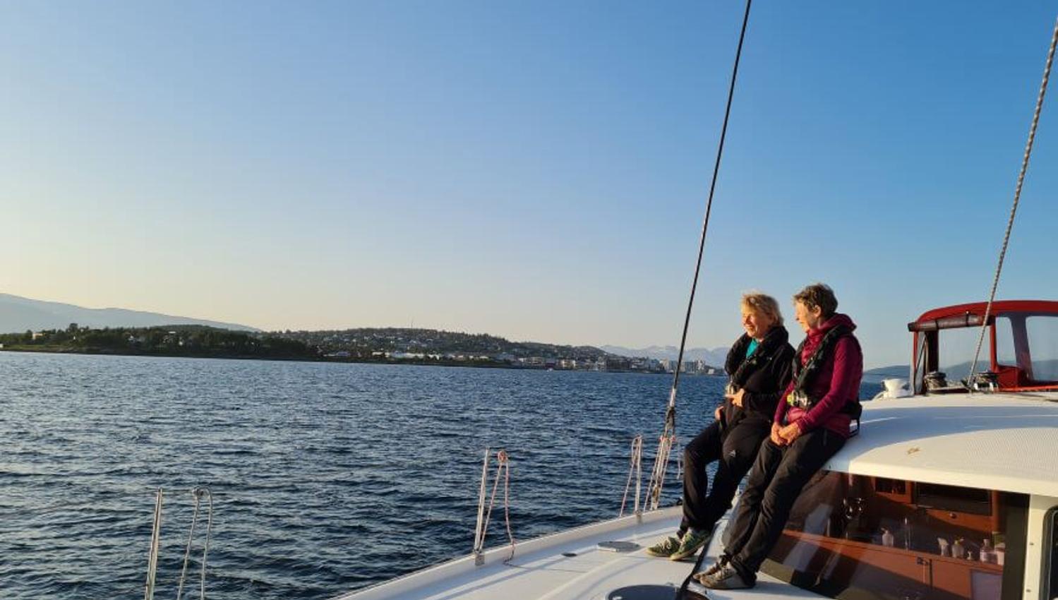 Two persons on deck on the Northern Yachting catamaran