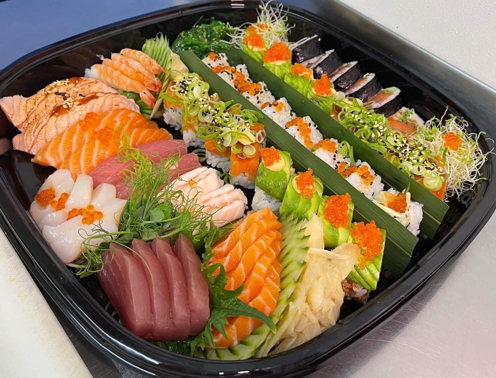 Ein elegant sushi-tallerken med fersk laks, tunfisk og sashimi, perfekt tilberedt hos Gjøa Sjømat i Rosendal.