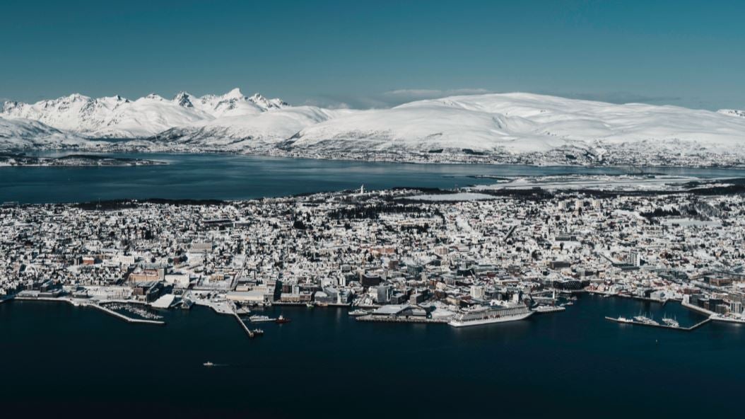 View over Tromsø with mountains and Arctic landscapes in the background.