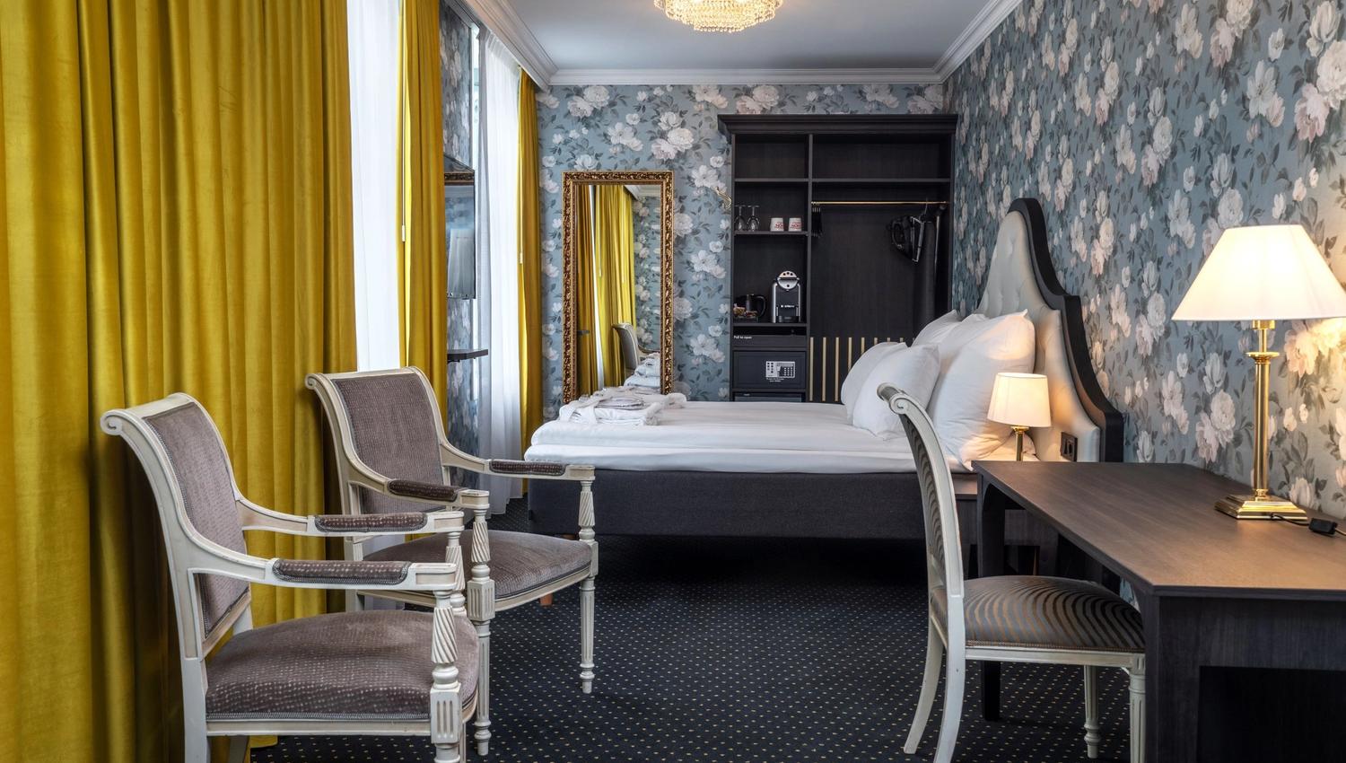 Luxurious hotel room at Thon Hotel Sandven, where modern comfort meets historic elegance.