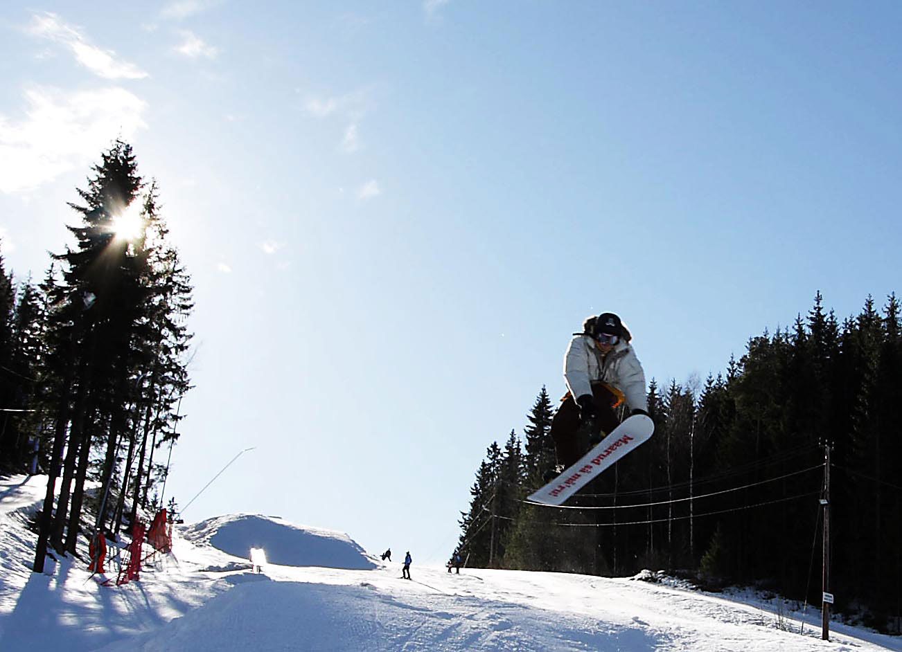 a person on a snowboard jumping in the air 