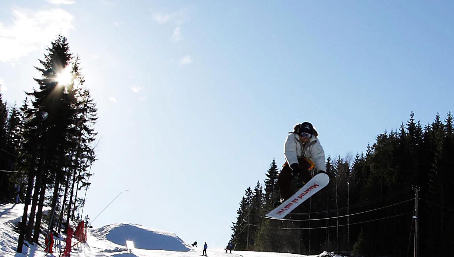 a person on a snowboard jumping in the air