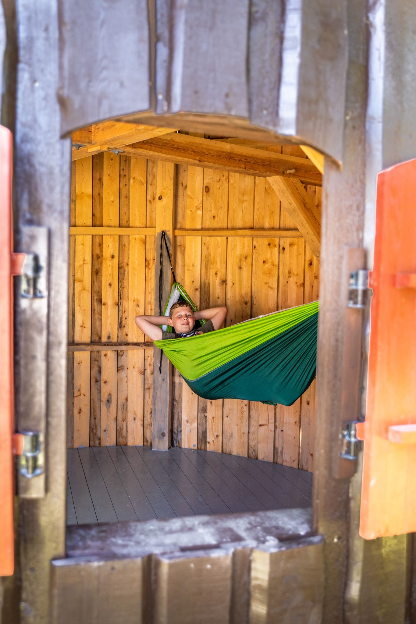 boy in a hammock in a hut