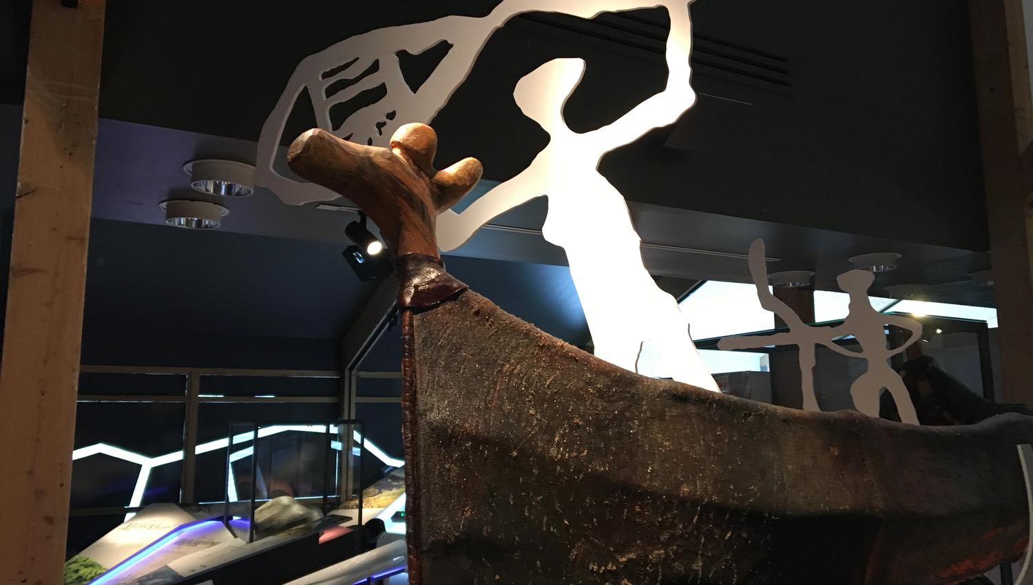 Explore the fascinating world of indigenous maritime culture! This beautifully crafted wooden canoe, featured in a modern exhibition, showcases rich heritage against a backdrop of contemporary design. Discover the stories and traditions that connect peopl
