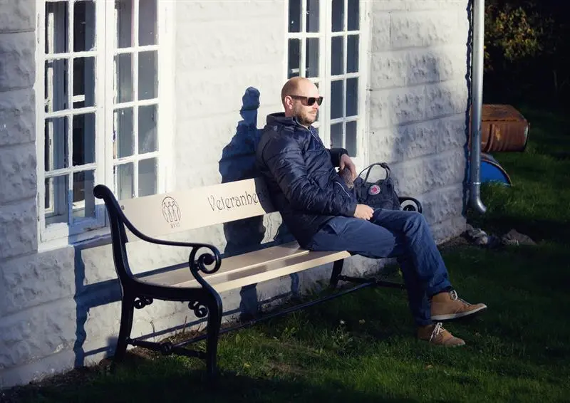 en mann som sitter på en benk