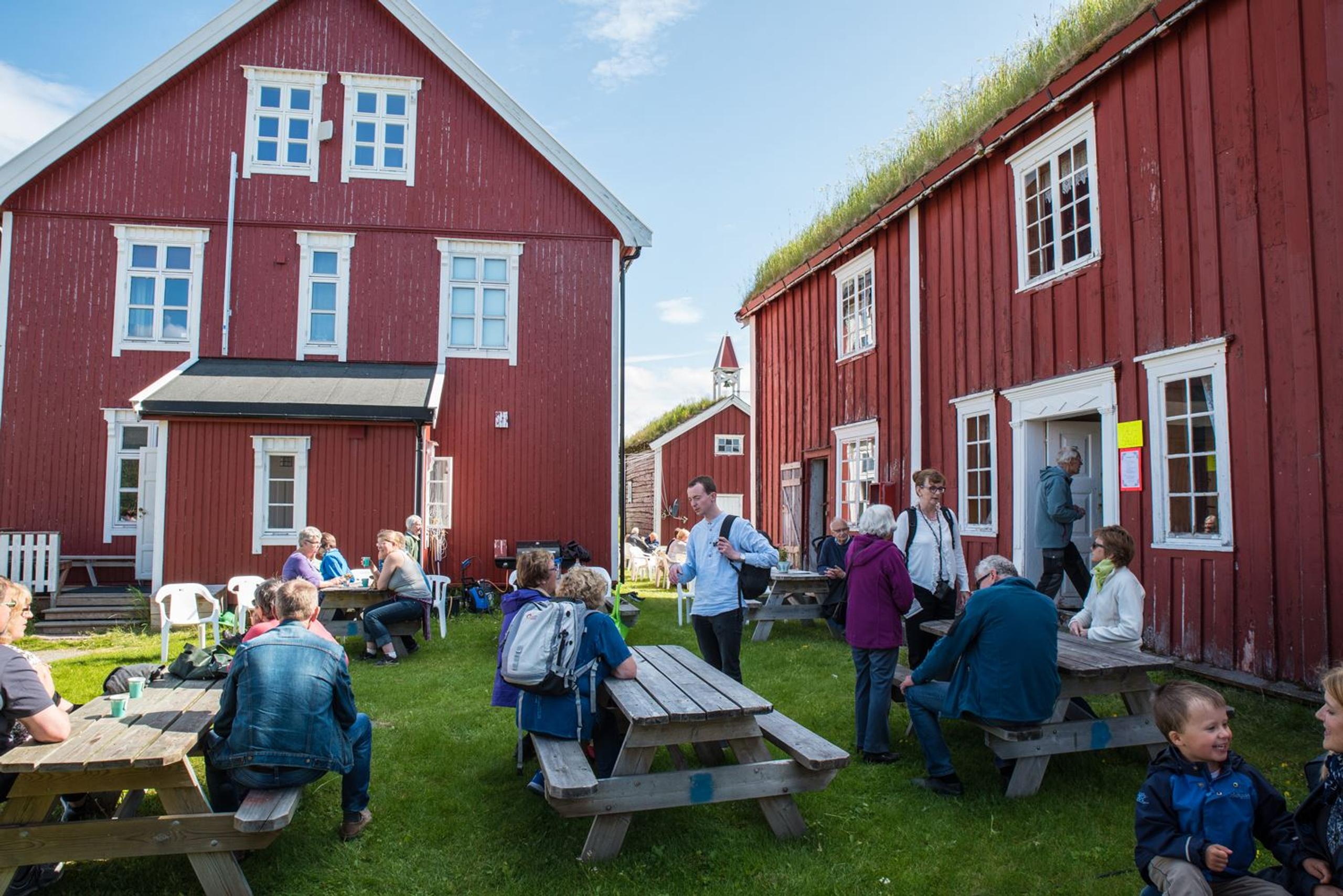 Gathering of people among traditional buildings.