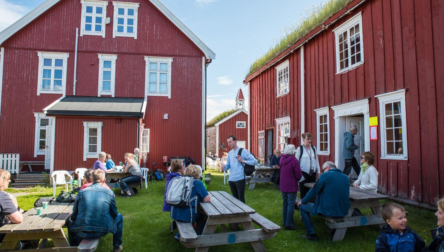 Gathering of people among traditional buildings.